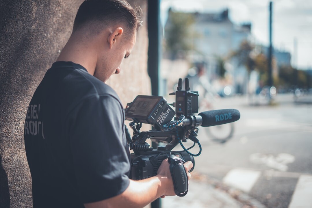 Journalist filming a breaking news story outdoors with professional video camera